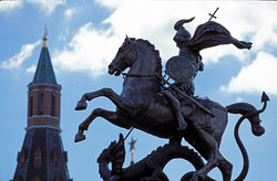 Sacred George's sculpture, piercing the snake, on a background of a tower of the Moscow Kremlin