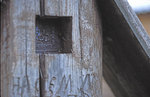 Detail of a gravestone cross with an ancient old believe icon